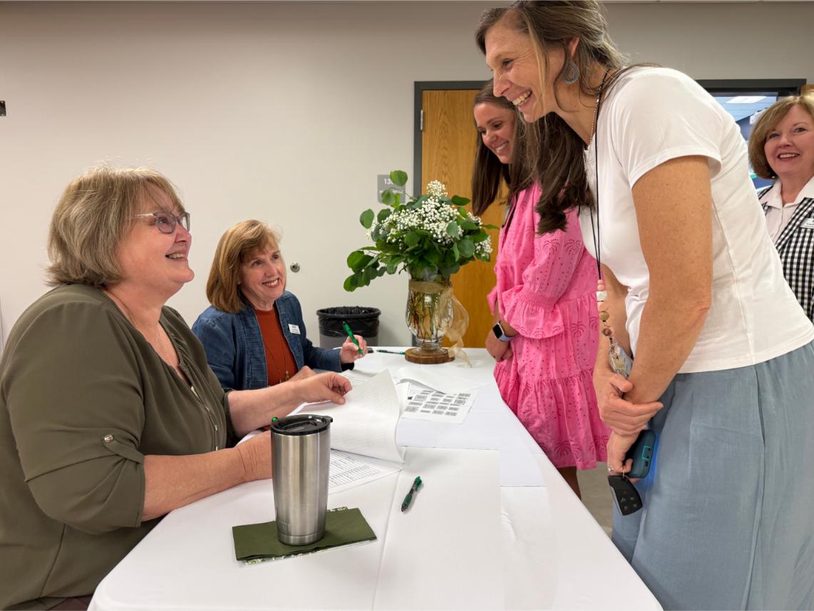 women checking in at check in table