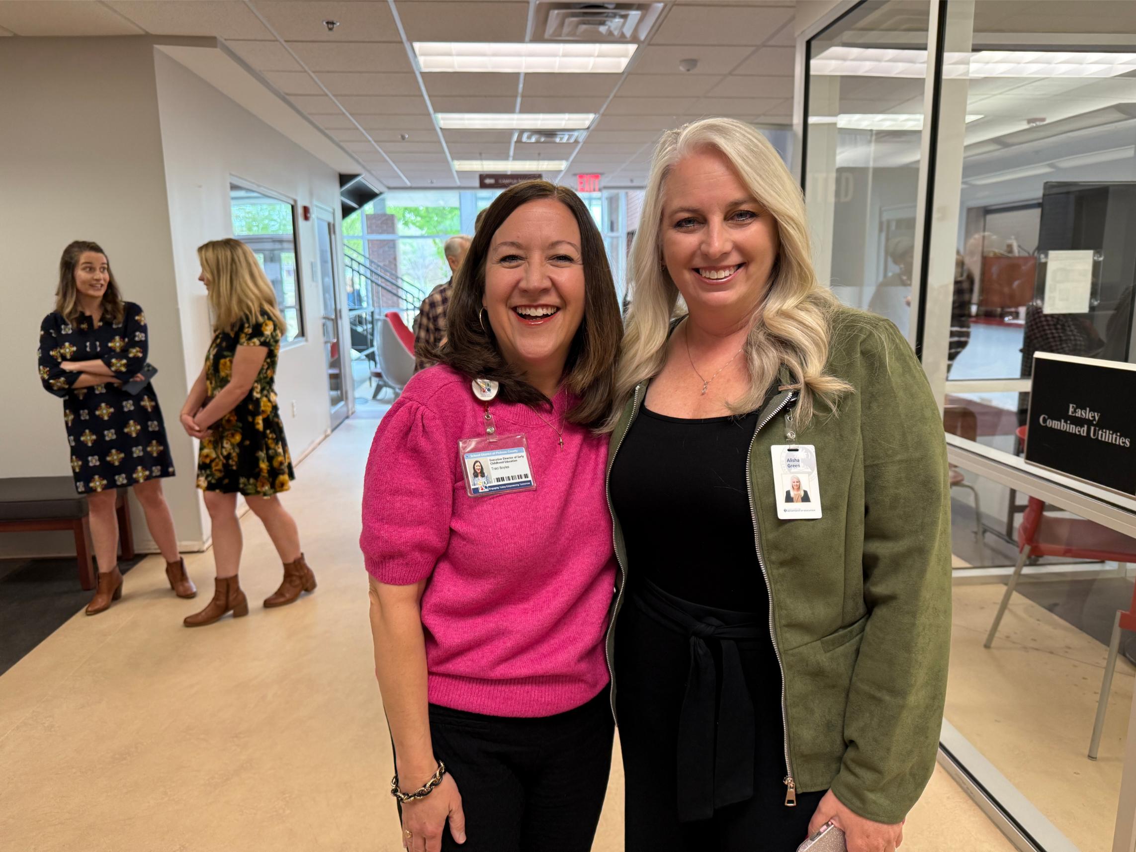 two women posing in reception area