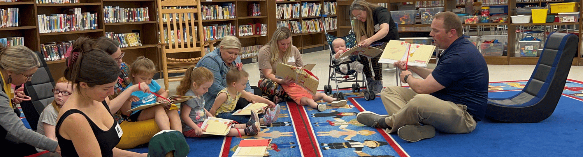 Preschool Pages teacher reads to children and their caregivers.
