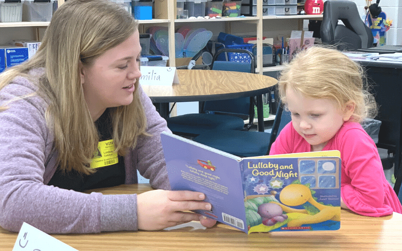 Mother and daughter read a book together