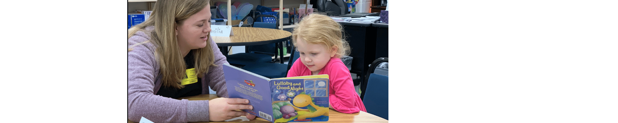 Mother and daughter read a book together