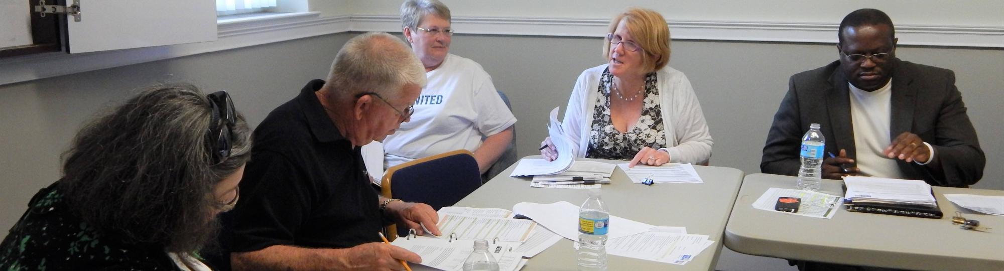 Impact Council members meet at a table