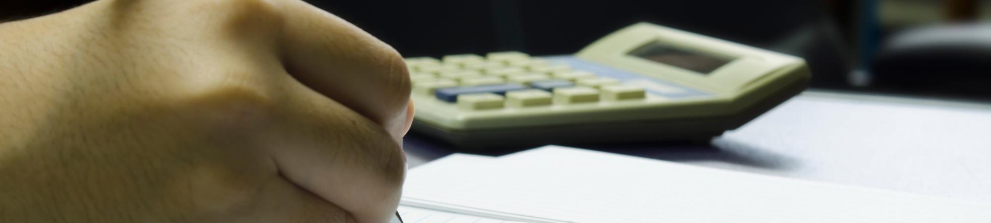 hand filling out taxes