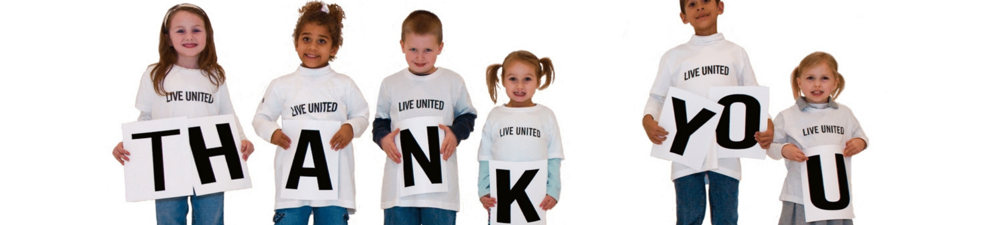children wearing Live United tshirts holding Thank You sign