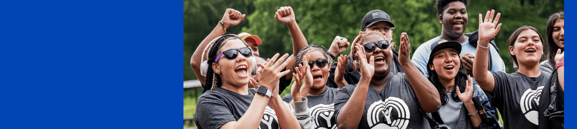 people wearing United Way logo t-shirts clap and cheer