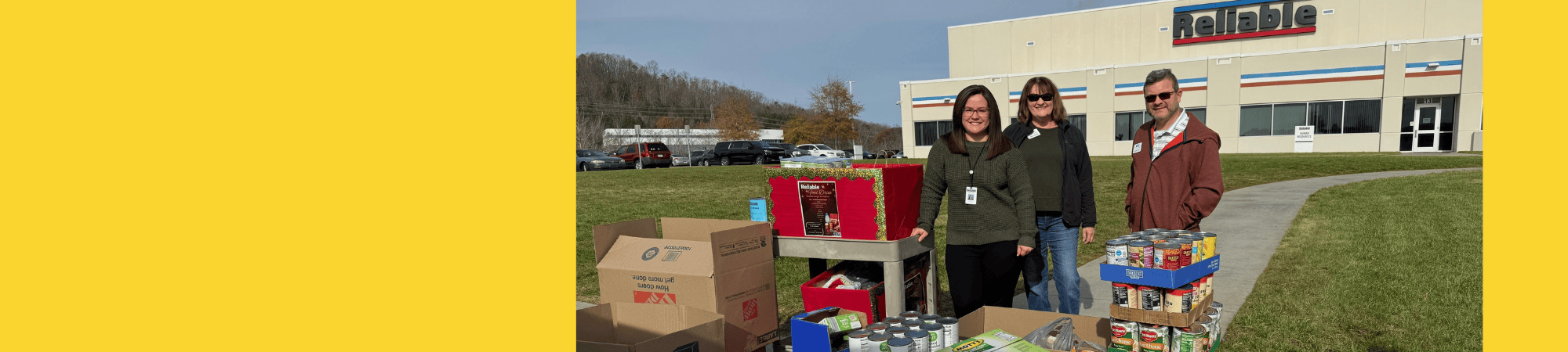 Reliable employees hosted a canned food drive. United Way staff pose with the Reliable rep and the canned food collected.