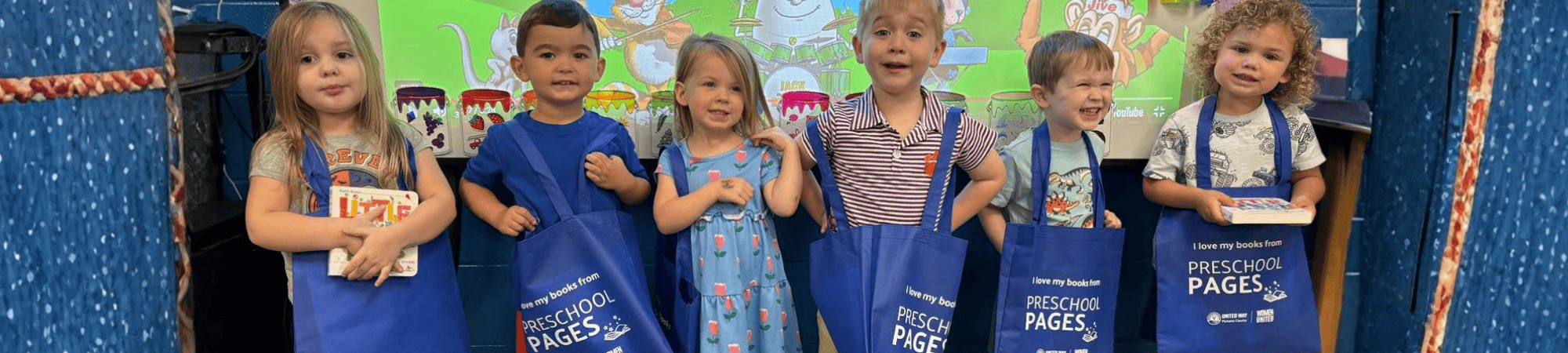 Preschool Pages children holding their book tote bags