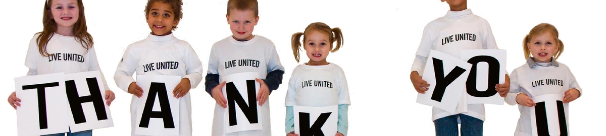 kids holding thank you sign