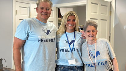 Three tax volunteers wearing Free File tshirts pose