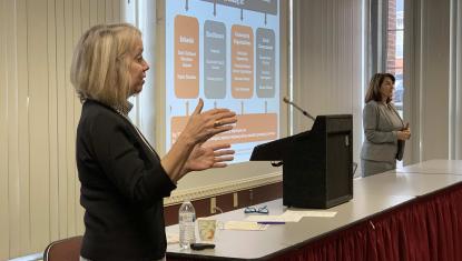 Dr. Mobley and Dr. Hossfeld speak from the podium.