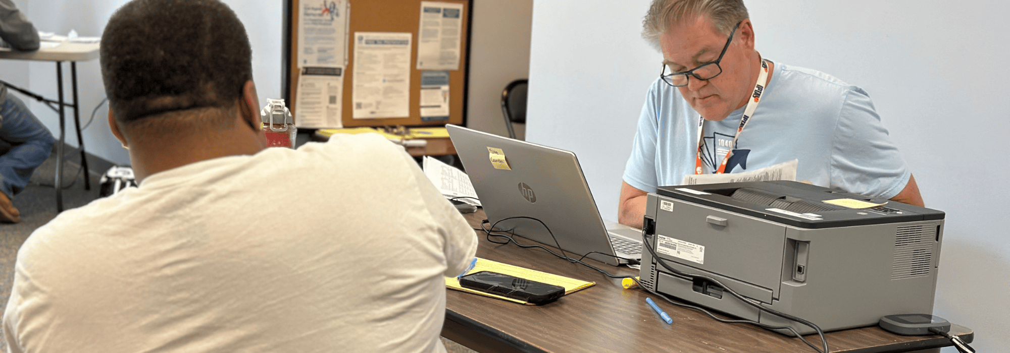 Free File volunteer meeting with taxpayer to do their taxes.