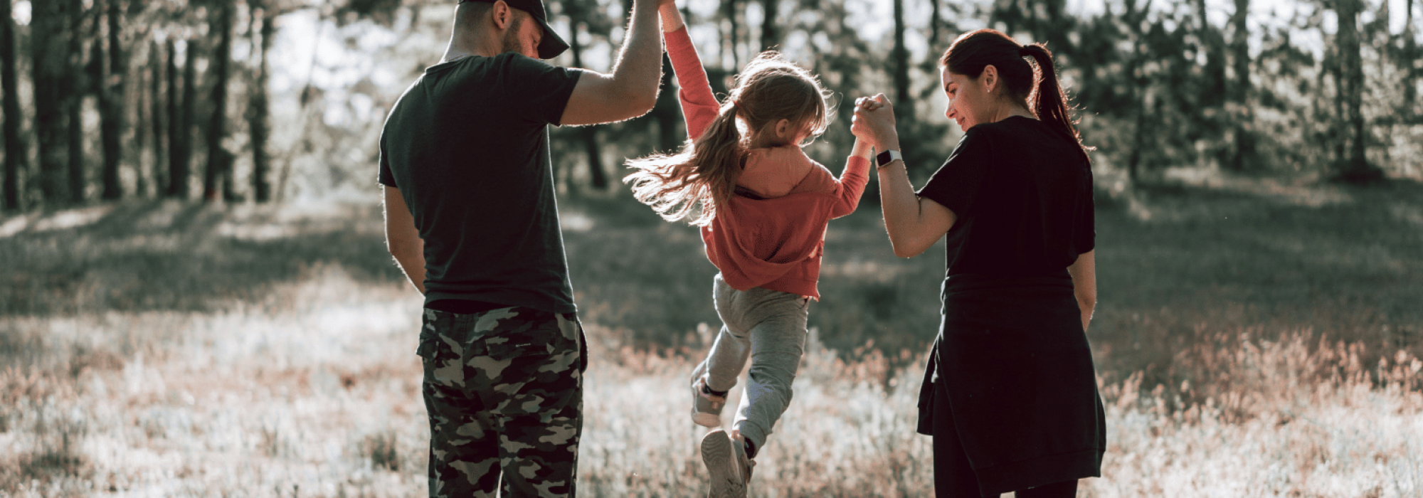 family lifting daughter