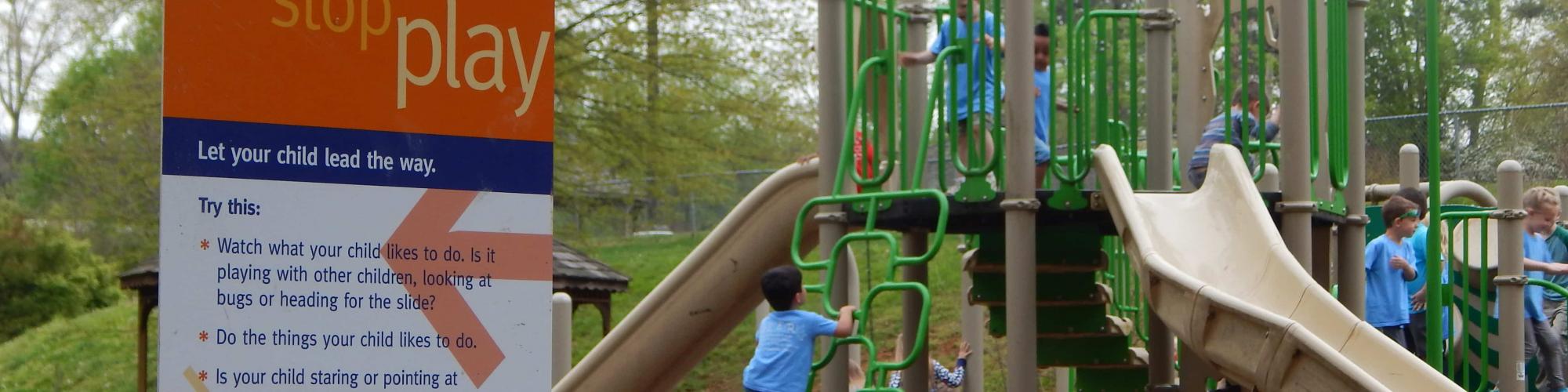 Children on a playground near a born learning trail sign