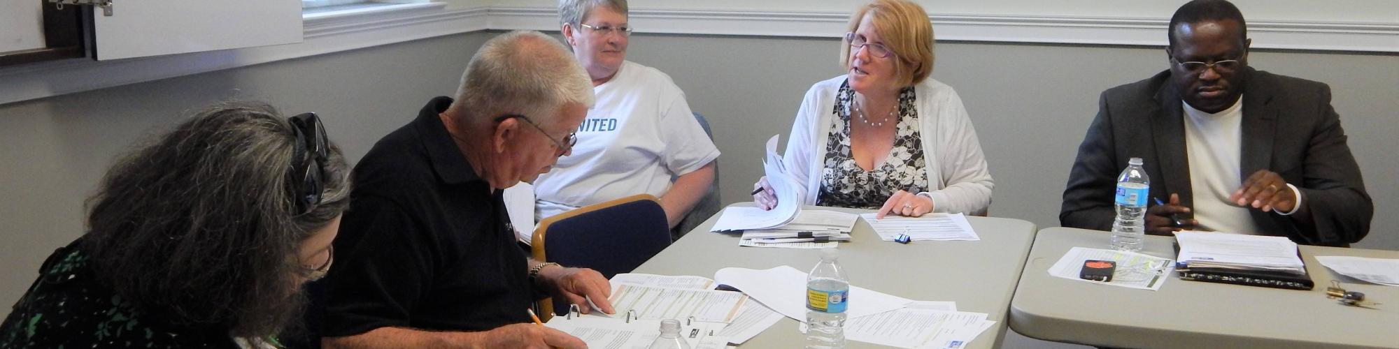 Impact Council members meet at a table