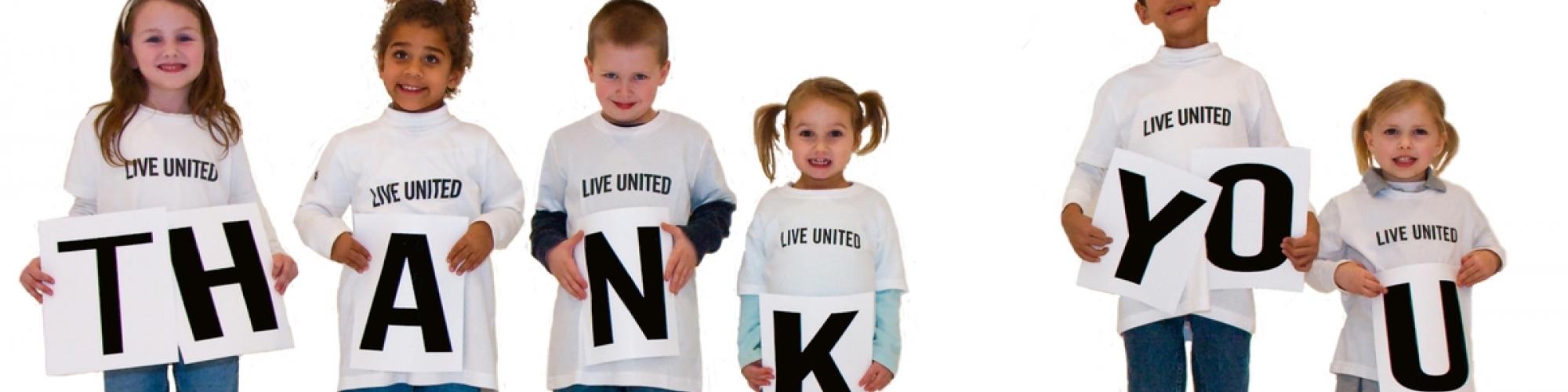 kids holding thank you sign