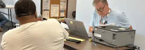 Free File volunteer meeting with taxpayer to do their taxes.