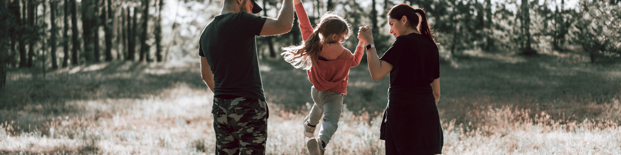 family lifting daughter