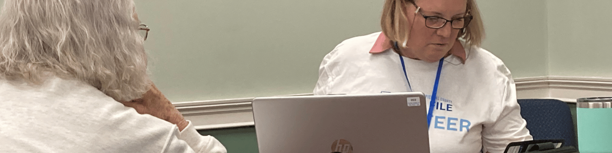 A female Free File volunteer helps another woman with her taxes